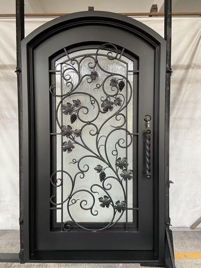 wrought iron single door with arched top and scrollwork