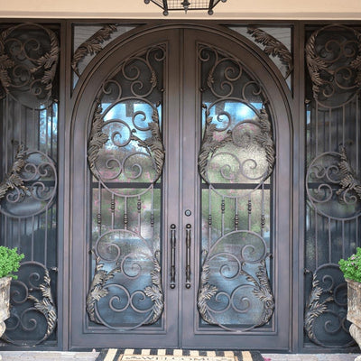wrought iron double door with round top and scrollwork