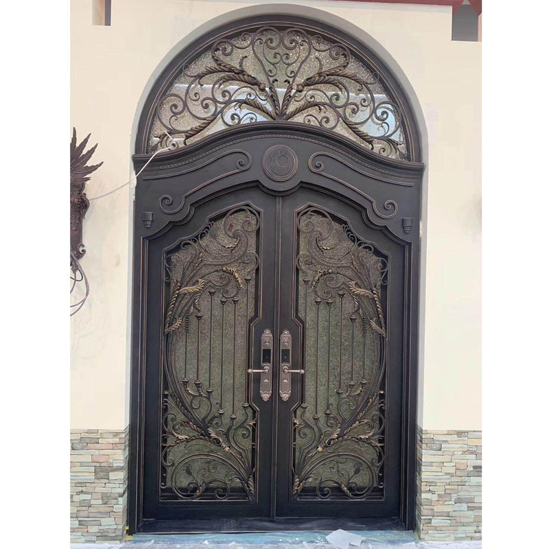 iron double exterior door with ornate scrollwork and round transom