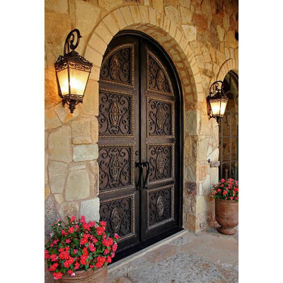 iron double exterior door with round top and scrollwork