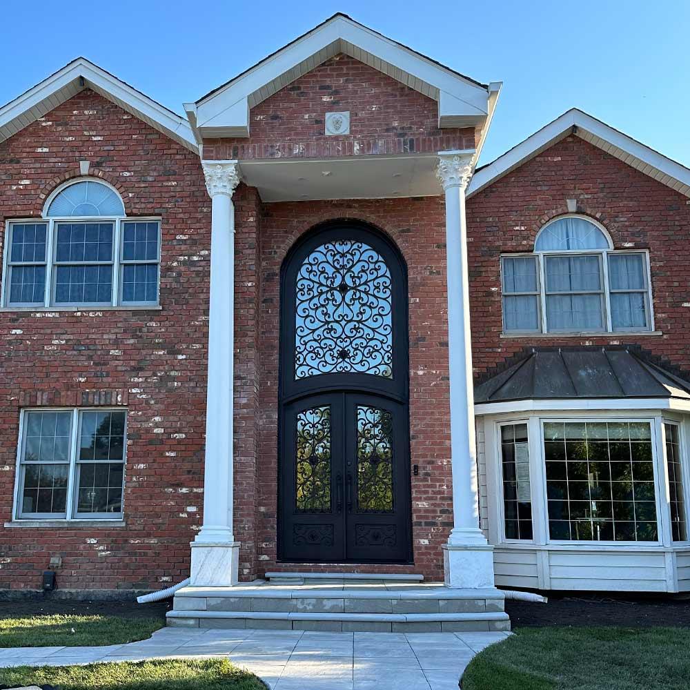 wrought-iron-double-door-with-beautiful-scrollwork-and-super-large-transom